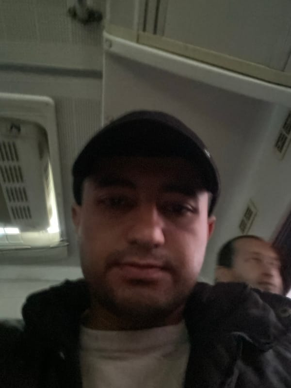 Two people photographed in vehicle interior in Bukhara