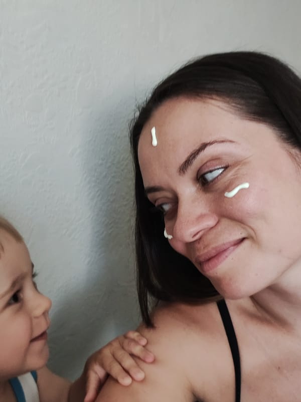 Woman applies face cream during photo session in Chaikovsky