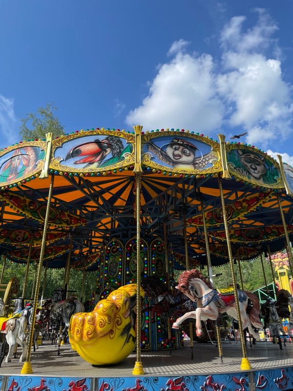 Ornate carousel spins on a sunny day in Novokuznetsk