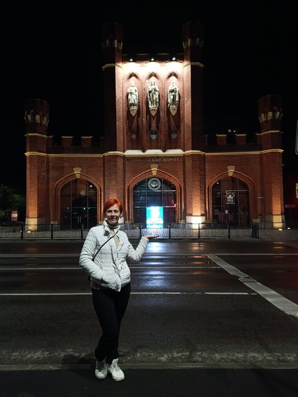 Woman stands on wet crosswalk near Brandenburg Gate, Kaliningrad