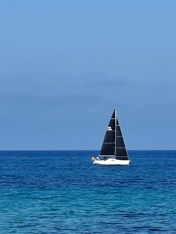 Sunny afternoon in Torrevieja: sailboat, sea, and Spanish architecture