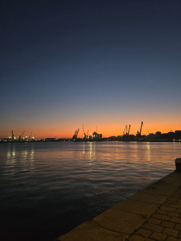 Burgas waterfront at dusk: harbor and cafe under a vivid sunset