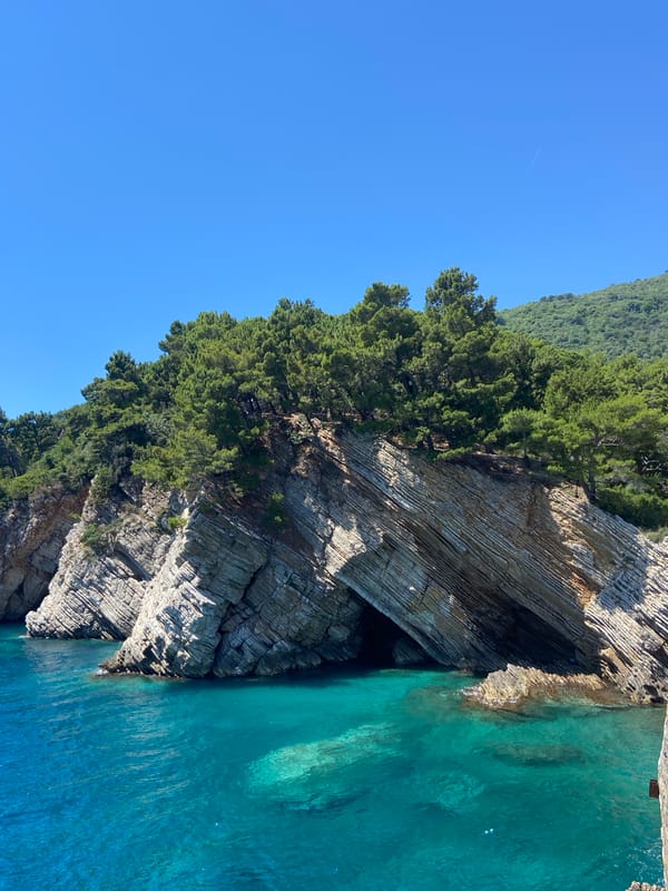 Cliffs, caves, and a cannon above a bright turquoise sea