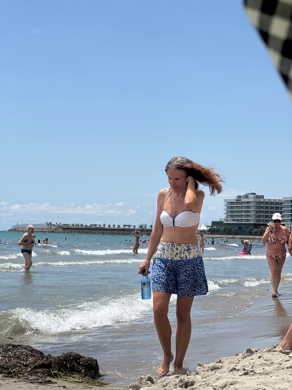 Busy urban beach day with lifeguards, sunbathers, and beachgoers