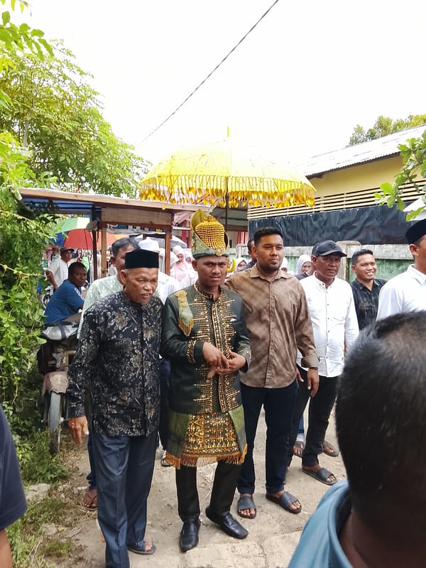 Funeral or ceremonial procession winds through Meunasah Raya village