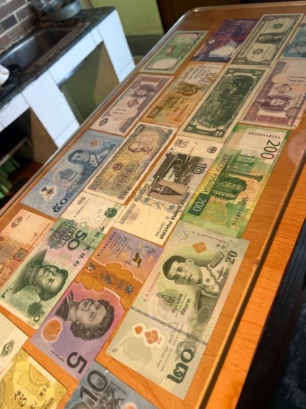 International currency collection displayed in Dharamshala, India