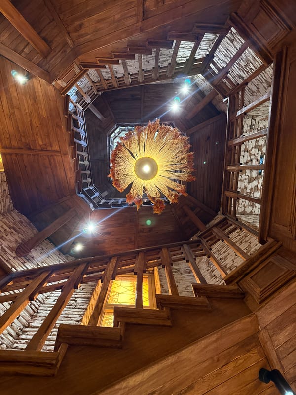 Low-angle views of a rustic wooden spiral staircase and brick facade
