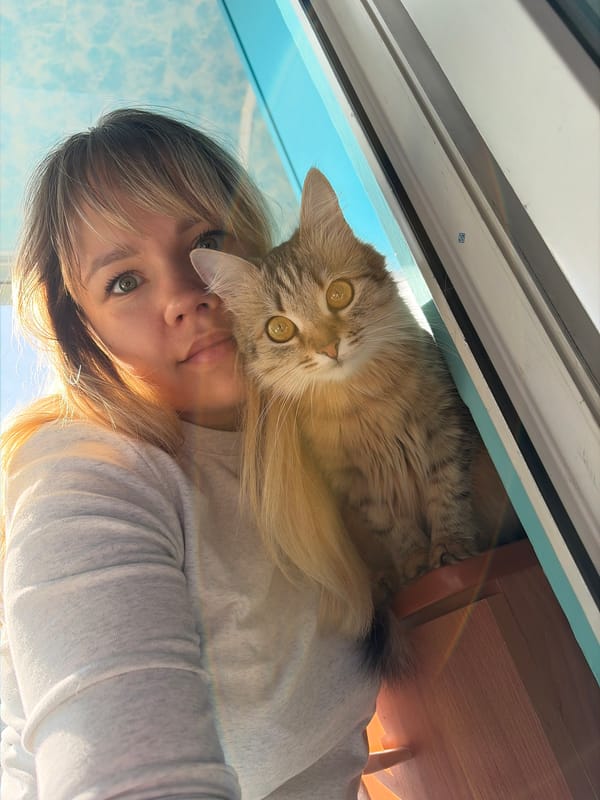 Woman and cats photographed in early morning Chaikovsky home