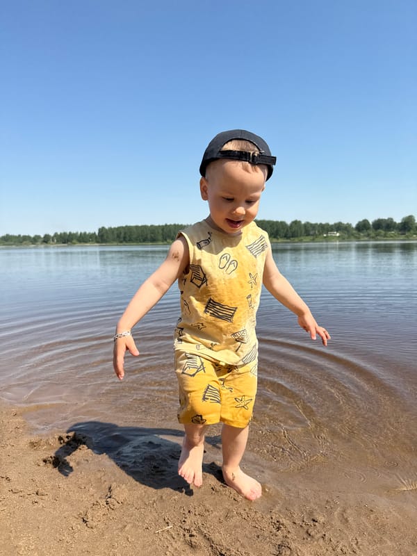 Toddler plays on beach in Rusanovo, Russia