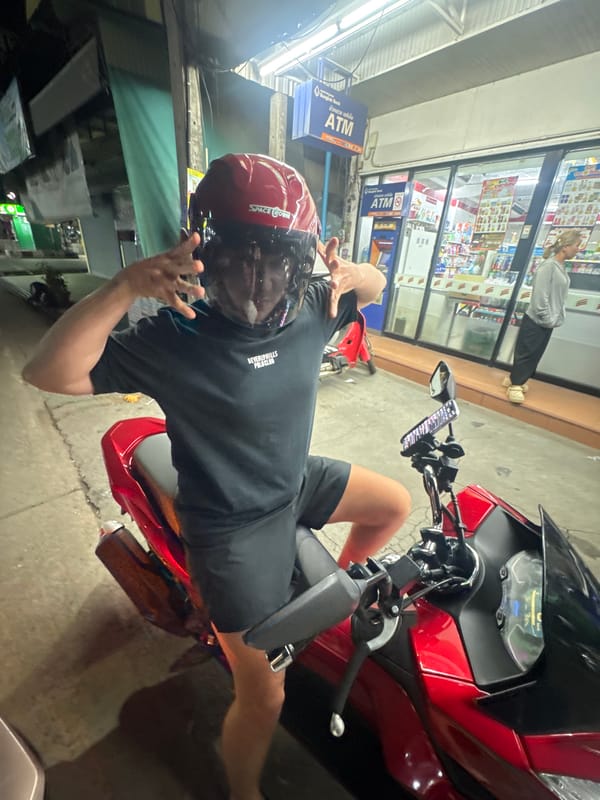 Evening convenience store scene with a motorcycle and a curious dog