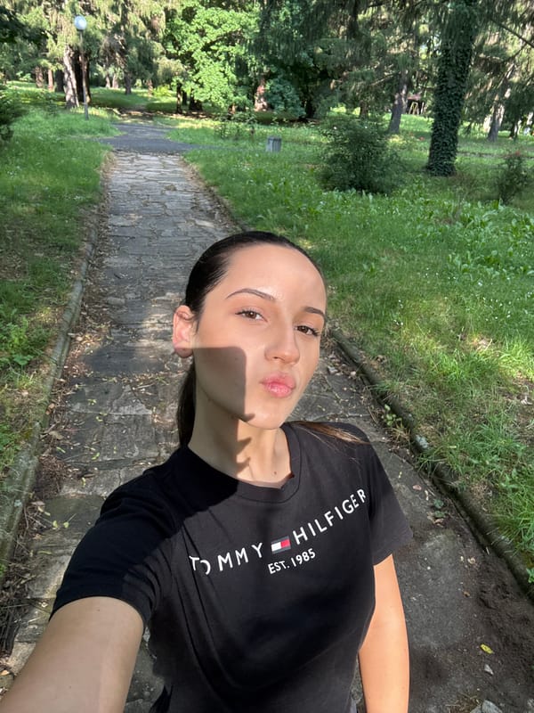 Woman takes sunny day selfies on bridge