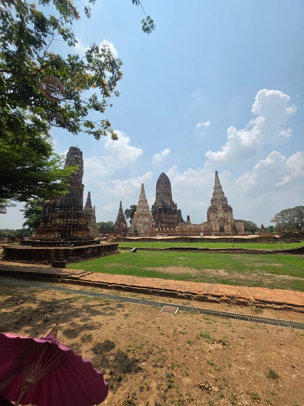 Tourist documents ancient Thai temple ruins during morning visit