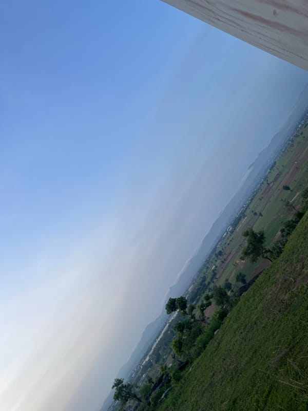 Trees, tilled fields, and open grassland in rural Jauro Yinu