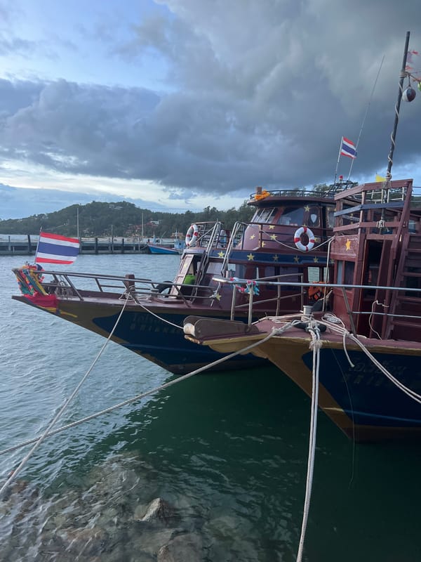 Koh Phangan harbor and surrounds, boats and construction equipment on a cloudy morning