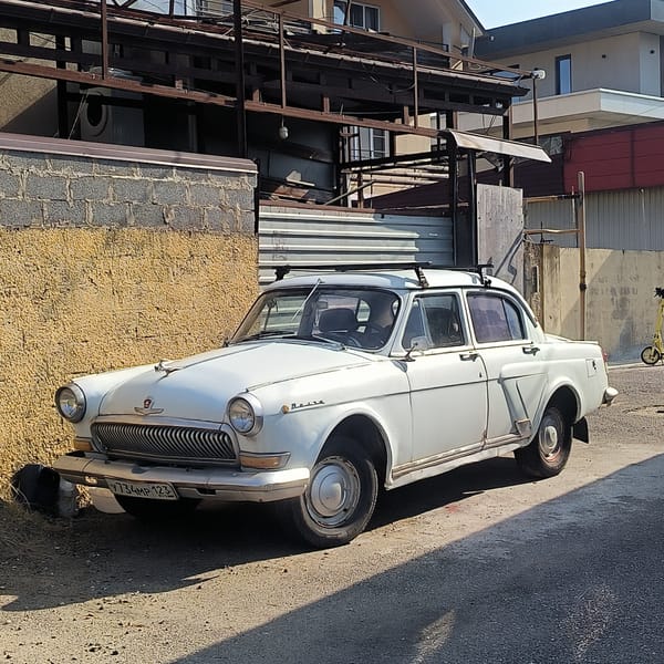 Vintage Volga and Porsche Boxster parked near Sochi, Russia
