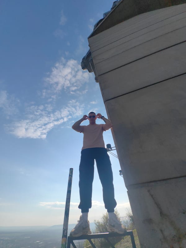 Man climbs monument structure in Shumen, Bulgaria during morning hours