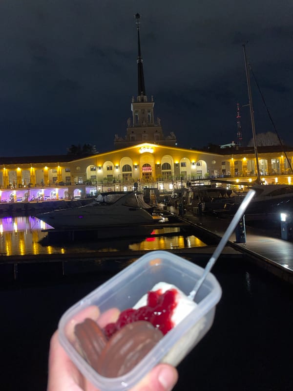 Person photographed with layered dessert container in Sochi