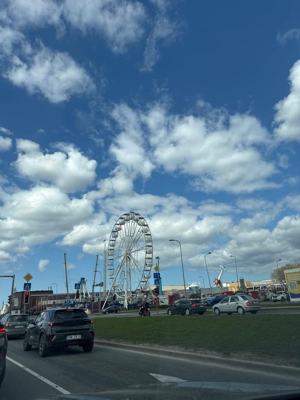 Ferris wheel operates in Riga amid morning traffic