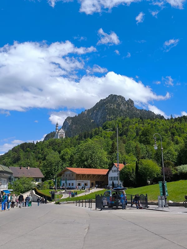 Tourist scenes captured in Schwangau featuring castle views, telescopes, carriages