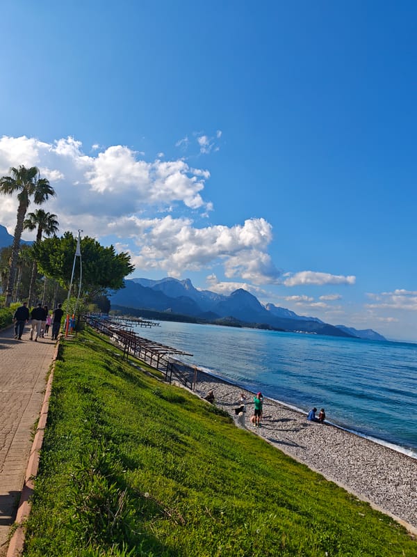 Tourist documents sunny afternoon stroll through Kemer, Turkey coastal town