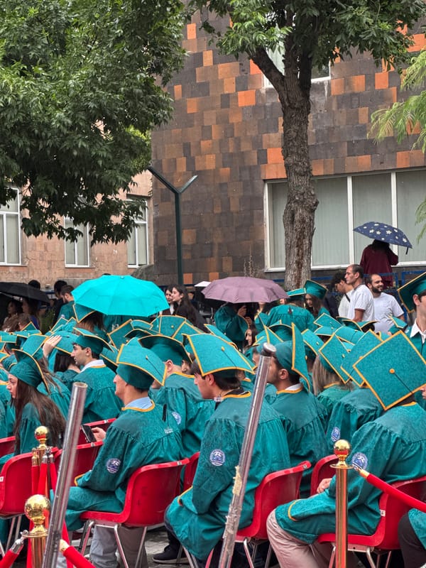 Outdoor graduation ceremony in Yerevan, teal gowns and roses