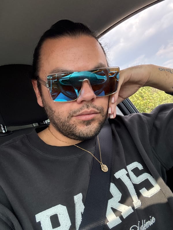 Person in vehicle wearing sunglasses and jewelry in Mexico