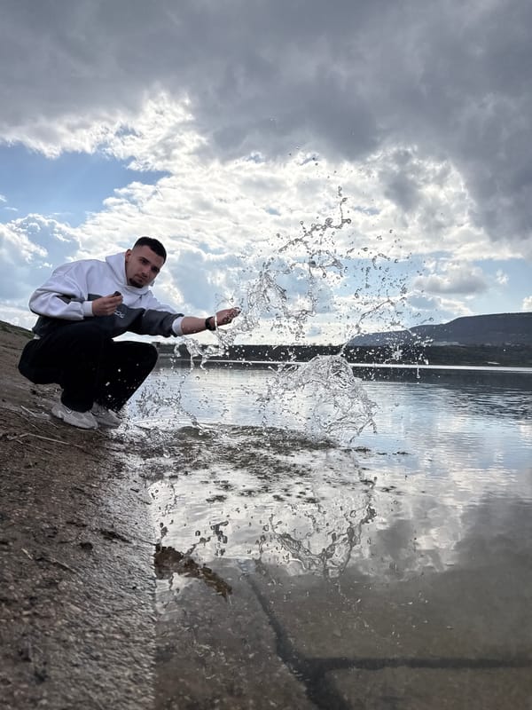 Man splashes water by hand near Shumen, Bulgaria waterway