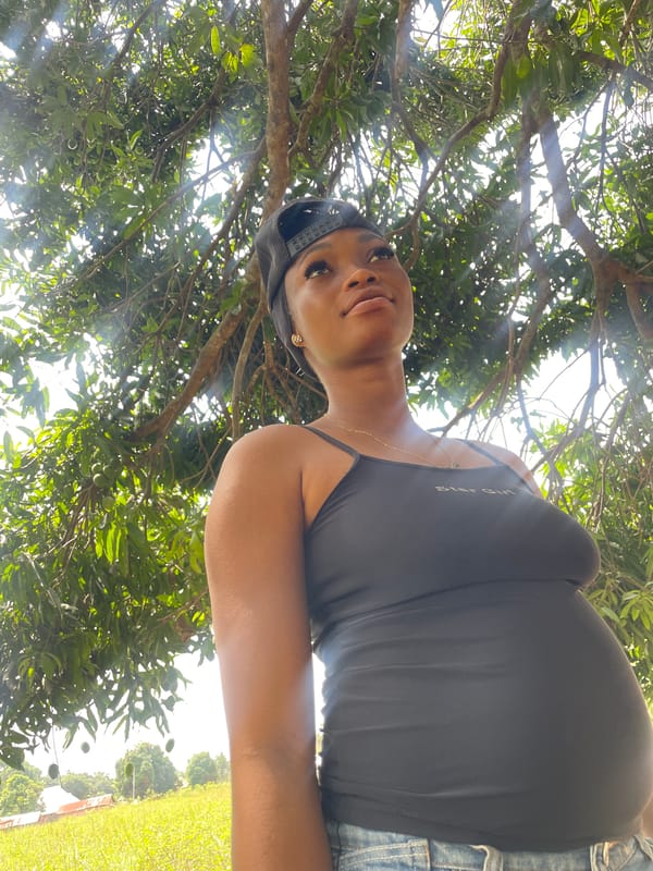 Woman gazes skyward in rural Ogbe, Nigeria