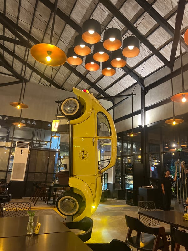 Upside-down yellow Beetle art installation draws visitors at Denpasar restaurant