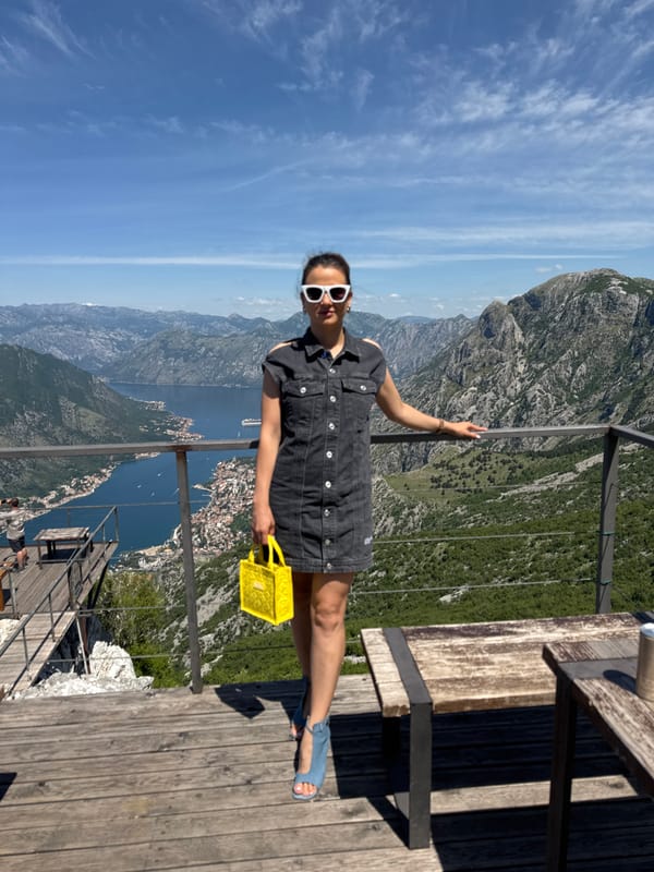 Woman enjoys mountain overlook with coffee in Montenegro