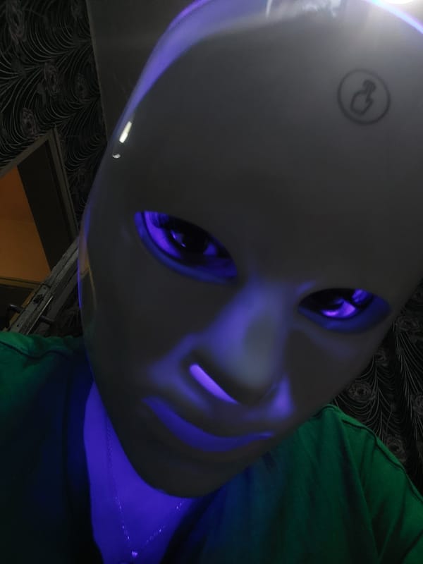 Person documented wearing LED-illuminated white mask with colored lighting