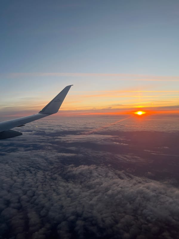 KLM passenger photographs sunset view from aircraft near Netherlands