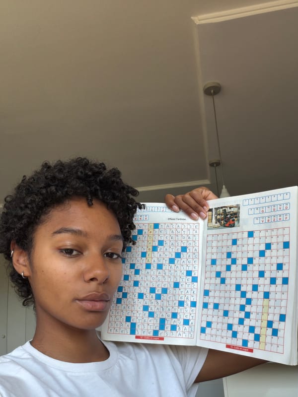 Woman solves crossword puzzles in Champs-sur-Marne cafe