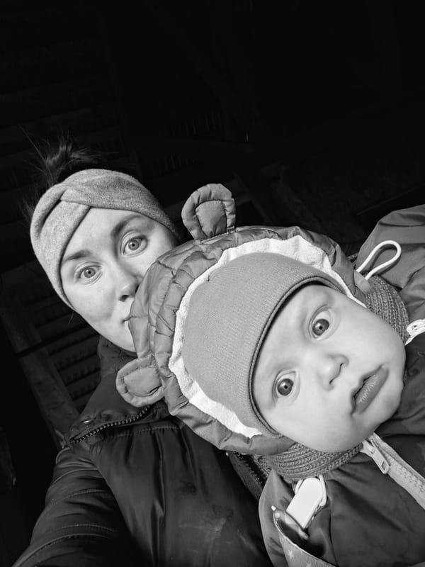 Baby in winter hat photographed in black and white portrait