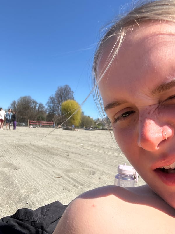 Woman rests on blanket at Vancouver beach location