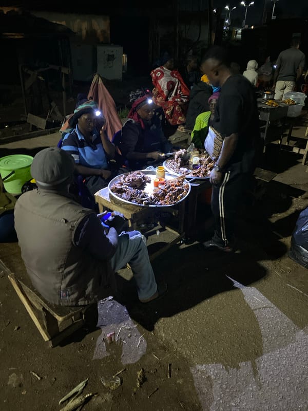 Night street food vendor serves customers in Bukuru, Nigeria