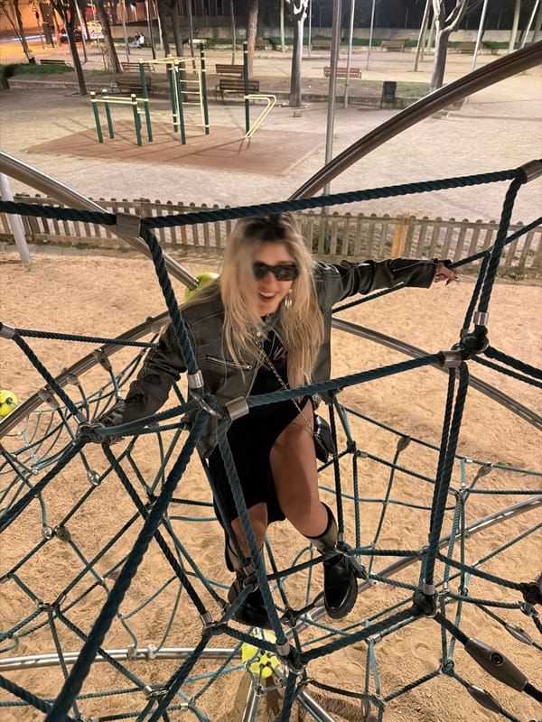 Two people play on Barcelona playground equipment
