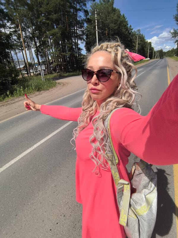 Hitchhiking and selfie on a sunny rural road in Russia