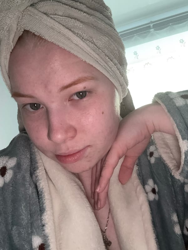 Person in towel and robe captured in indoor setting