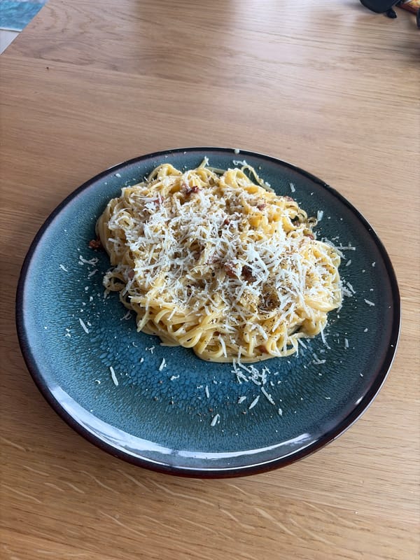 Spaghetti carbonara up close on a wooden table in Rijswijk