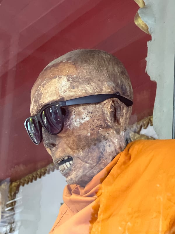 Mummified monk display and traditional blessings at Baan Hua Thanon temple