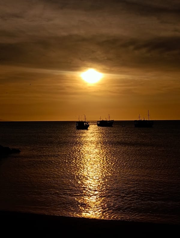 Sunset captured over Juan Griego coastline with monument