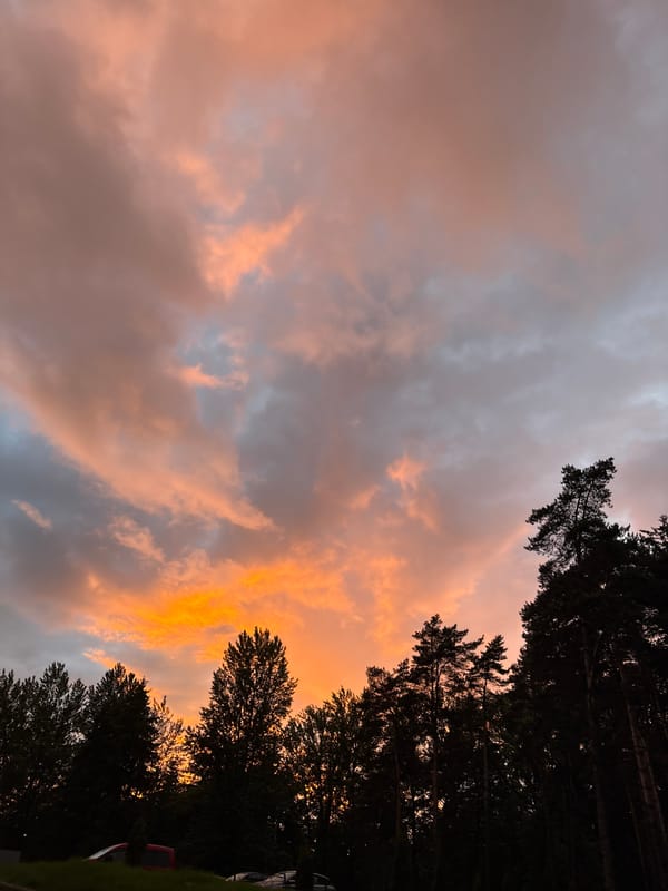Dramatic sunset with orange-pink clouds observed across Minsk neighborhoods