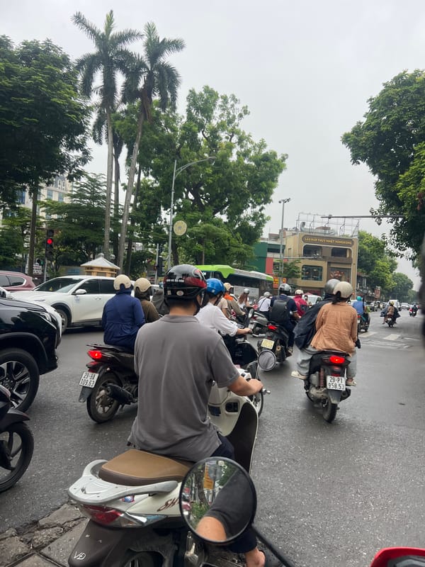 Busy Hanoi streets near government buildings on a wet morning