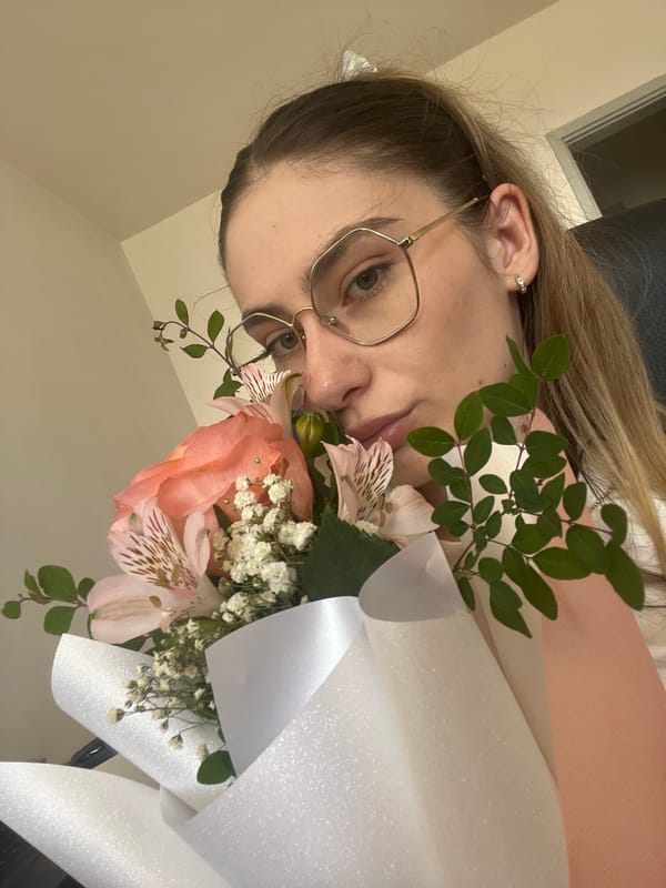 Up close with a fresh bouquet of peach roses and pink flowers