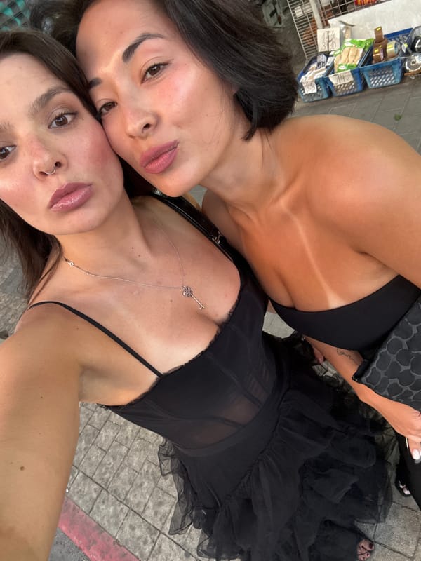 Two women take selfie on busy Tel Aviv street