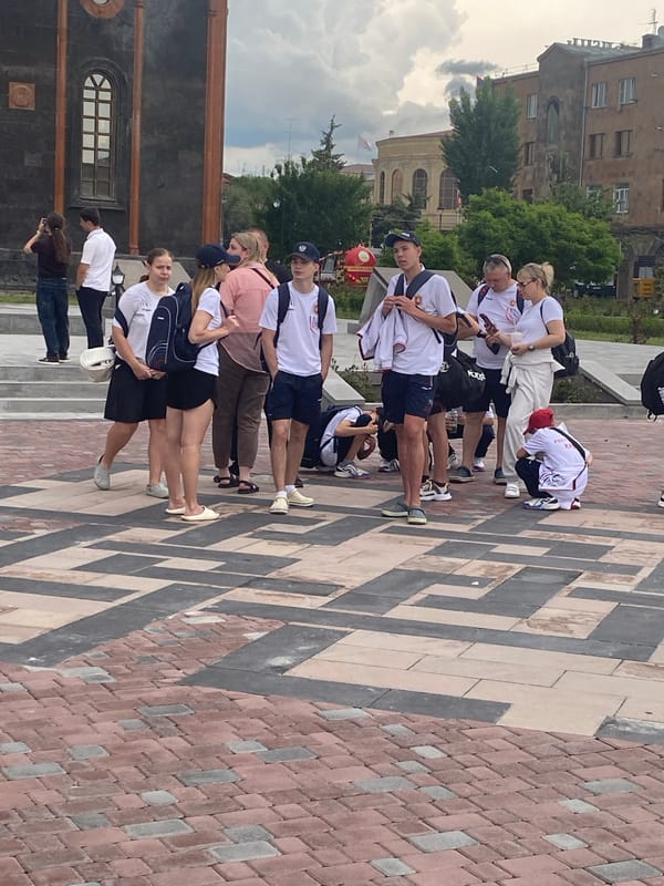 Group gathers outside historic stone building in Gyumri