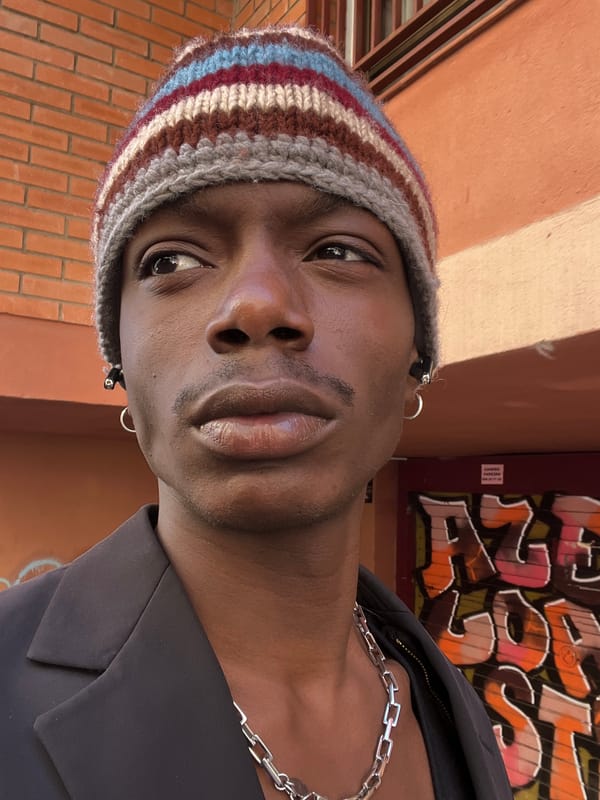 Person in striped beanie documented across Barcelona locations