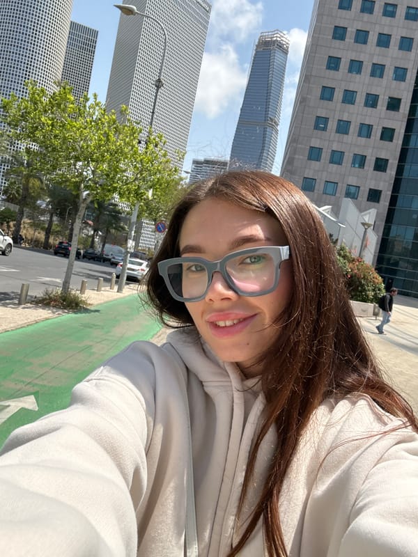 Woman takes selfie in sunny Tel-Aviv street