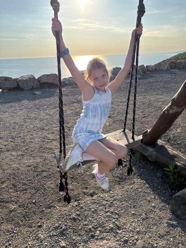 Child swings at sunset in Montenegro countryside